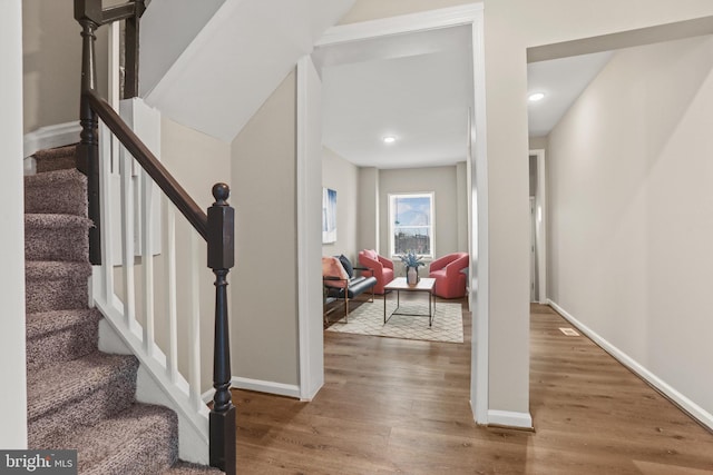 staircase with wood-type flooring