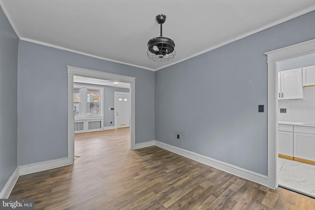 unfurnished dining area featuring wood-type flooring and ornamental molding