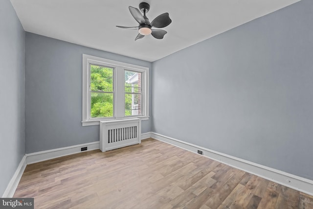 empty room with ceiling fan and light wood-type flooring