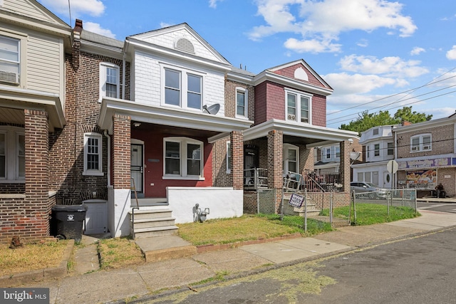 townhome / multi-family property with a porch