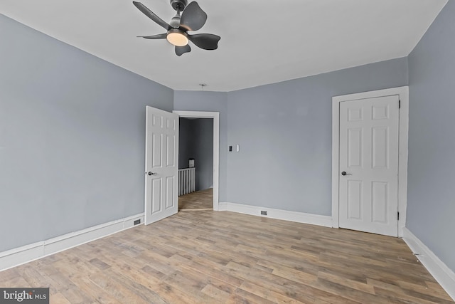 spare room with ceiling fan and hardwood / wood-style floors