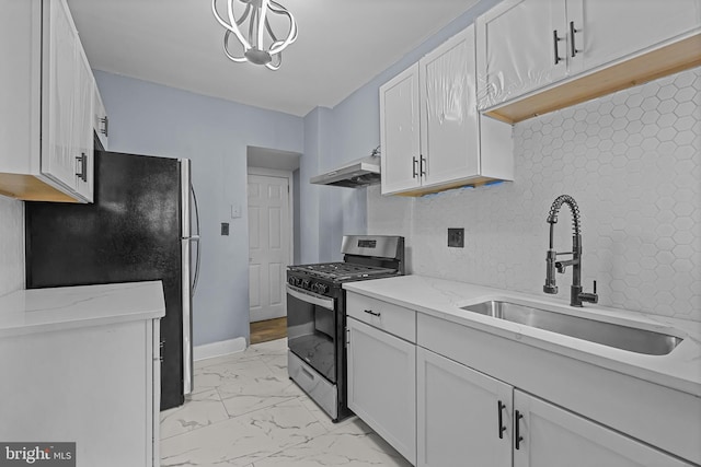 kitchen featuring white cabinetry, sink, stainless steel range with gas cooktop, ventilation hood, and black refrigerator