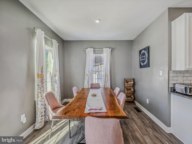 dining area with dark hardwood / wood-style floors