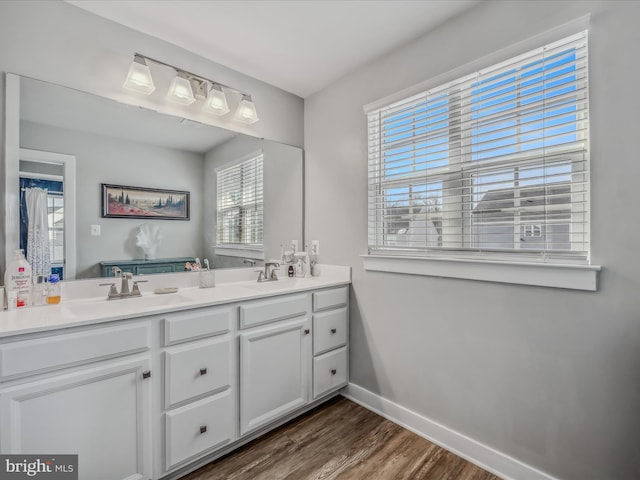 bathroom with hardwood / wood-style floors, plenty of natural light, and vanity