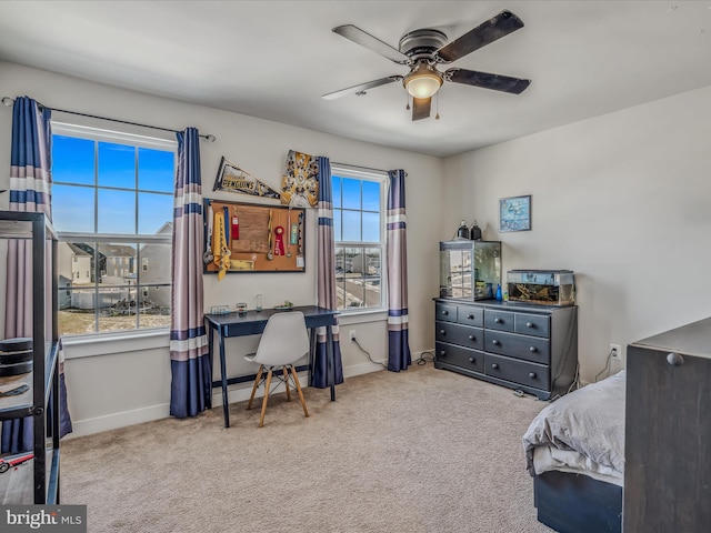 carpeted bedroom featuring ceiling fan and multiple windows