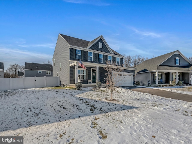 front of property featuring covered porch and a garage