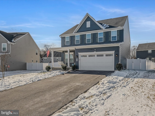 view of front of property featuring a garage and a porch