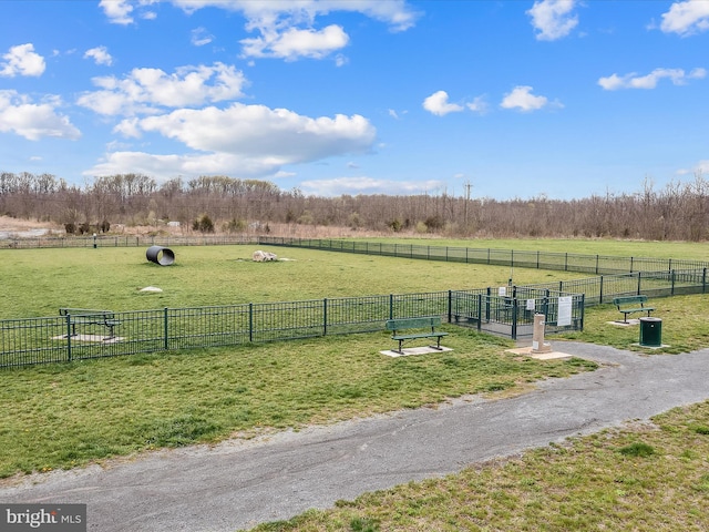 view of community featuring a rural view and a lawn