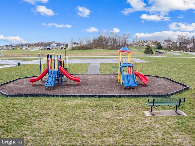 view of jungle gym featuring a lawn