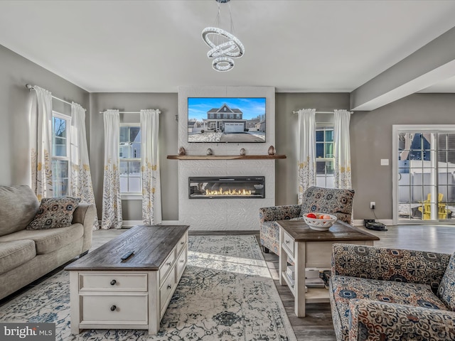 living room with a chandelier and light hardwood / wood-style flooring