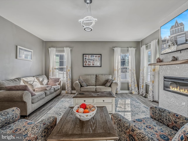 living room with hardwood / wood-style flooring and an inviting chandelier