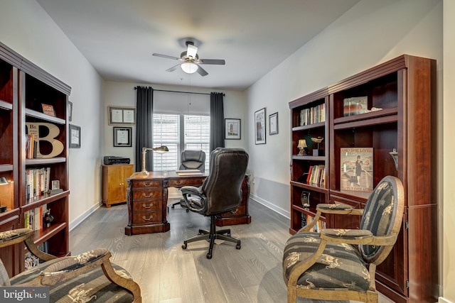 home office featuring hardwood / wood-style flooring and ceiling fan