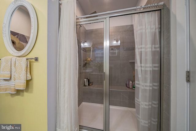 bathroom featuring a shower with shower door