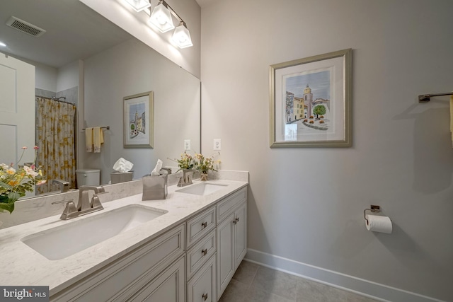 bathroom with vanity, tile patterned floors, toilet, and walk in shower