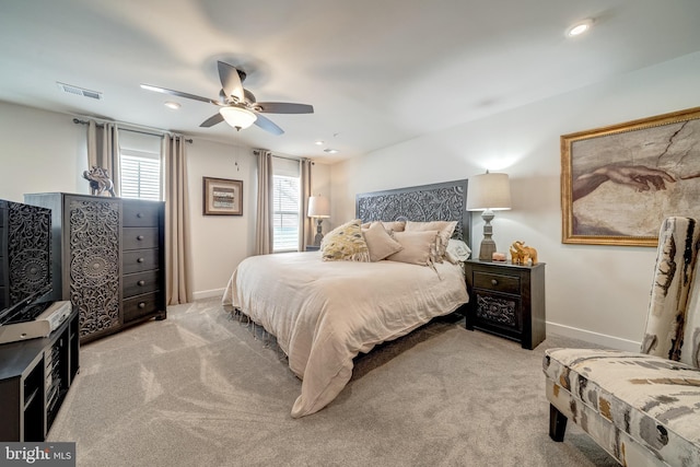 bedroom featuring light carpet and ceiling fan