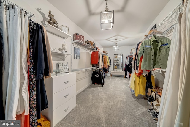 walk in closet featuring light carpet