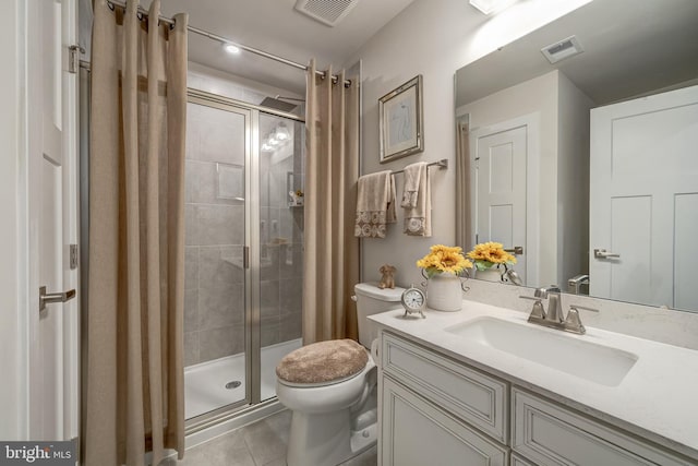 bathroom with tile patterned flooring, walk in shower, vanity, and toilet