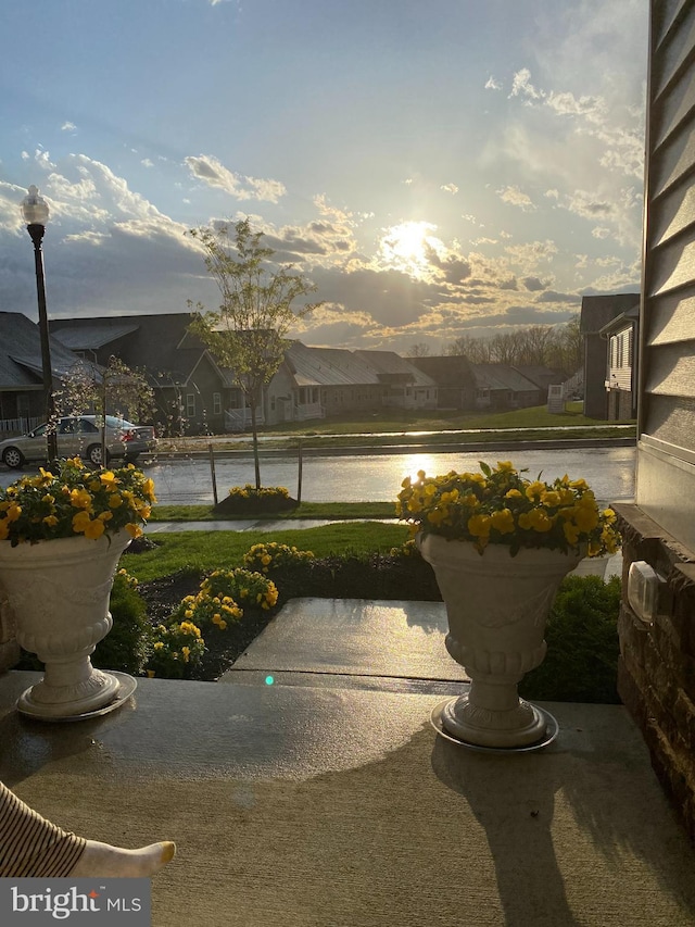 patio terrace at dusk featuring a water view