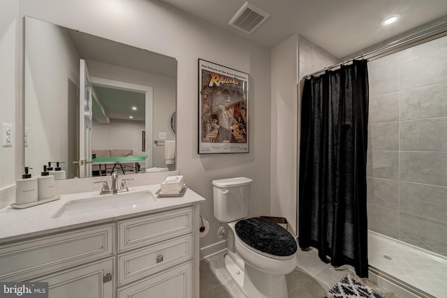 bathroom featuring toilet, vanity, tile patterned floors, and a shower with shower curtain