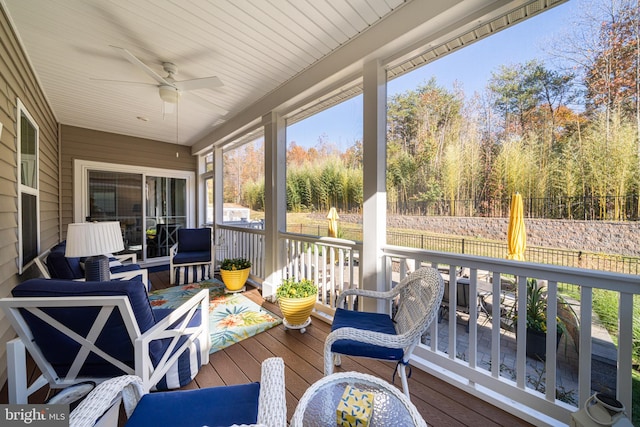 sunroom / solarium featuring ceiling fan