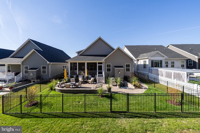 rear view of property with a yard, a sunroom, and a patio