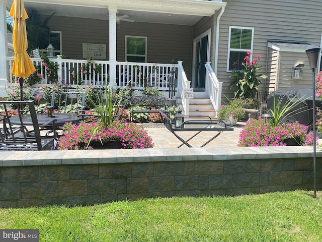 view of exterior entry featuring covered porch