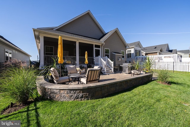 back of property with a patio and a lawn