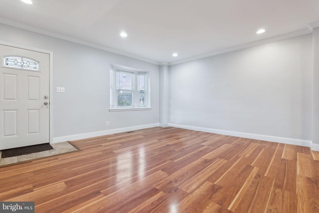 foyer entrance featuring hardwood / wood-style flooring and ornamental molding