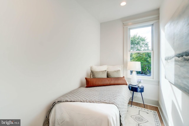 bedroom with hardwood / wood-style flooring