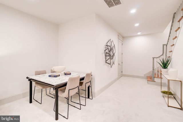 dining area with light colored carpet