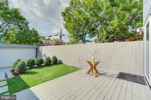 wooden deck with a lawn