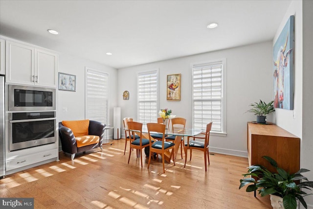 dining space with light hardwood / wood-style floors