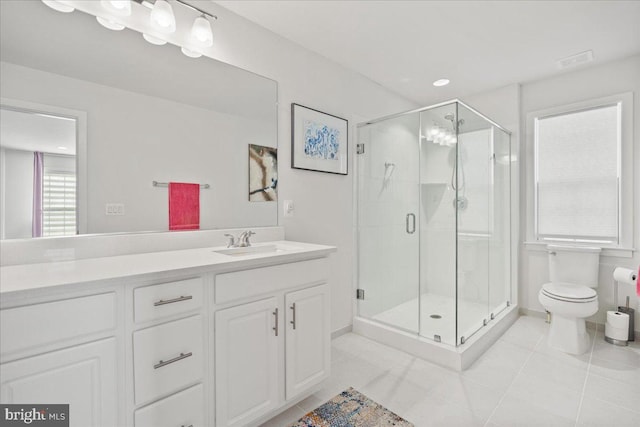 bathroom featuring toilet, tile patterned flooring, walk in shower, and vanity