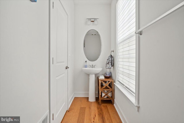 bathroom featuring sink, hardwood / wood-style floors, and plenty of natural light