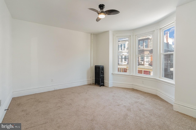 carpeted spare room with ceiling fan and a healthy amount of sunlight