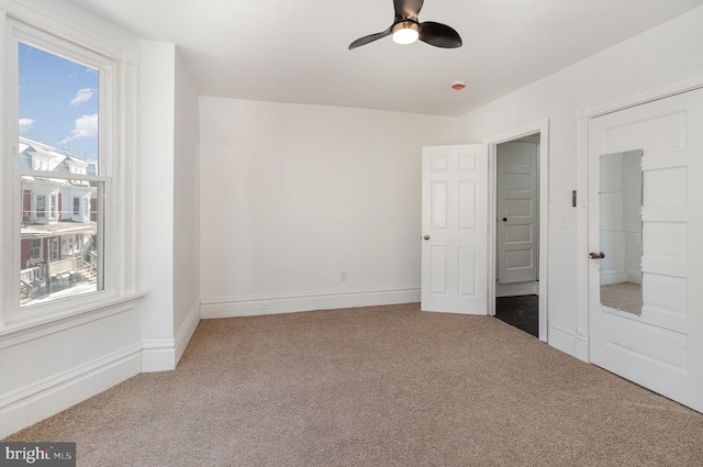 unfurnished bedroom featuring carpet and ceiling fan