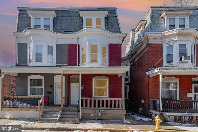 view of front facade with a porch and cooling unit