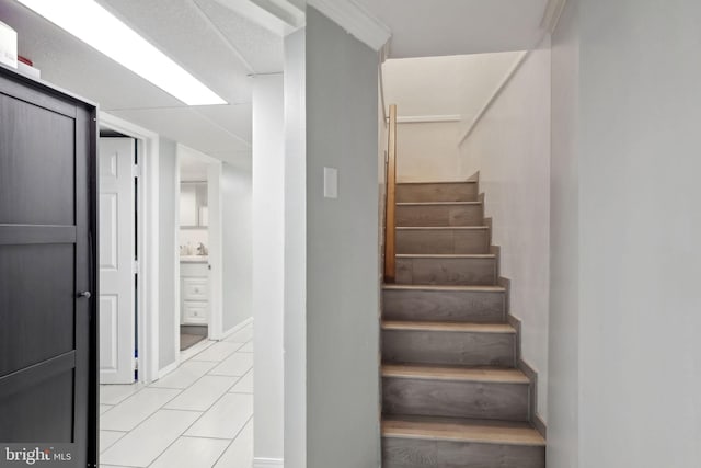 staircase featuring tile patterned flooring