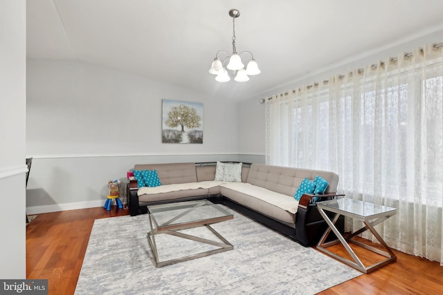 living room with wood-type flooring and a notable chandelier