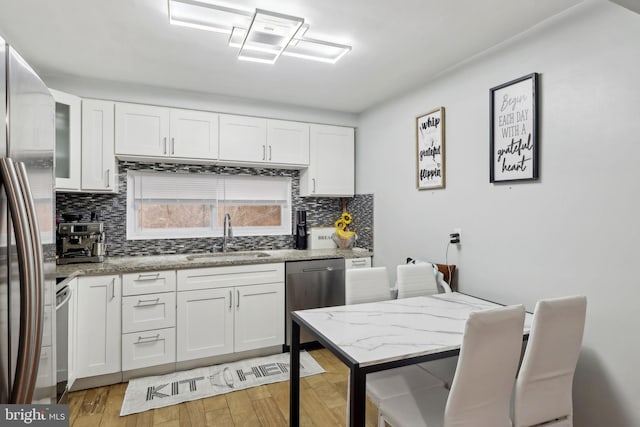 kitchen with white cabinetry and sink