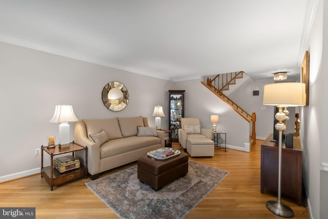 living room featuring wood-type flooring and ornamental molding