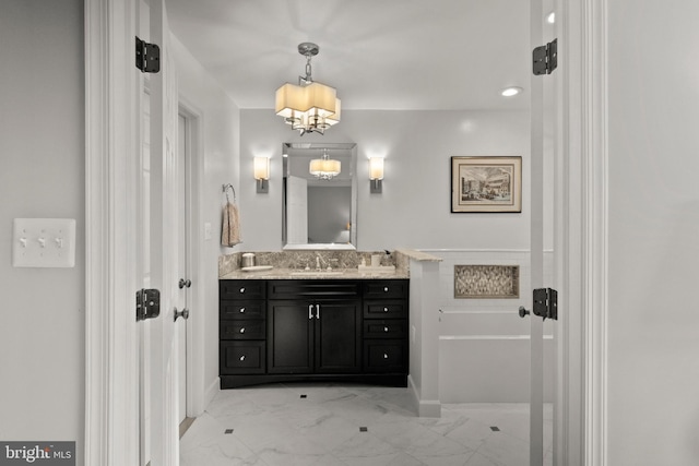 bathroom with vanity and an inviting chandelier