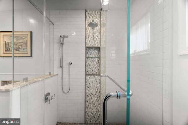 bathroom featuring a shower with door