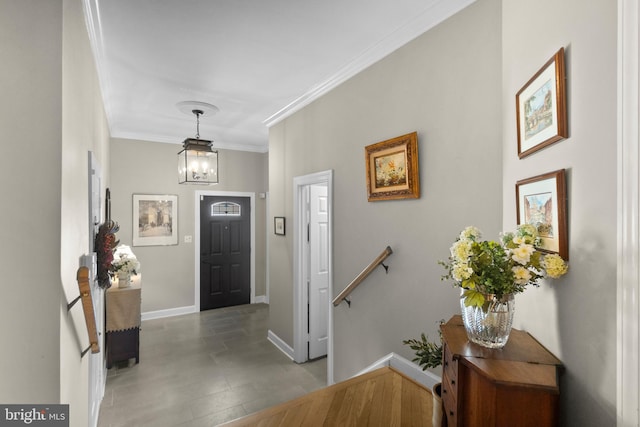 entryway with baseboards and crown molding