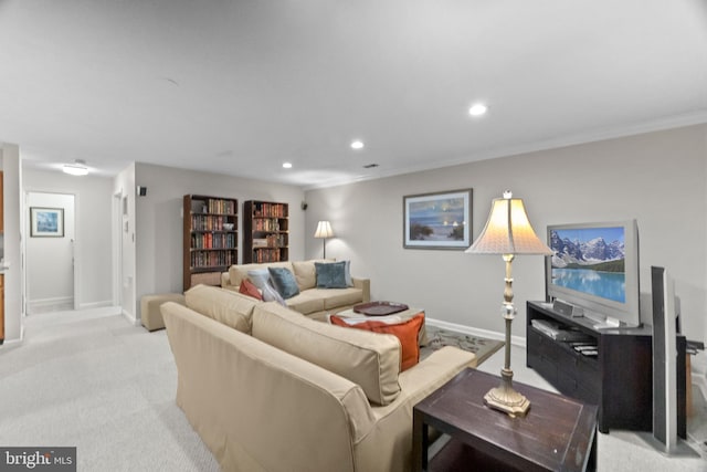 carpeted living room with ornamental molding