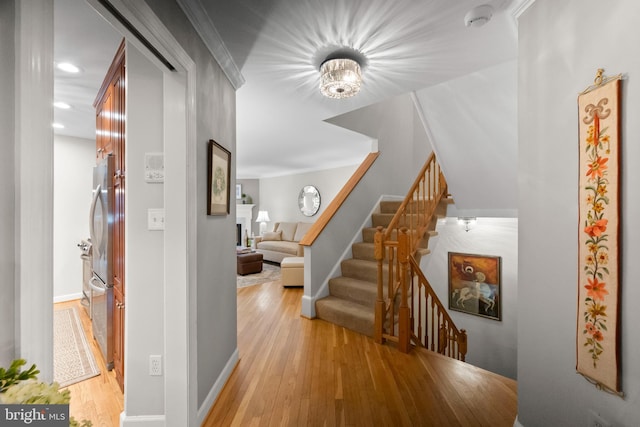 interior space featuring ornamental molding and light wood-type flooring