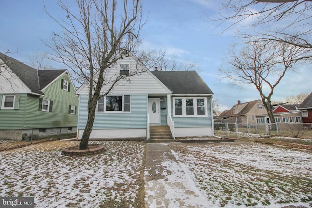 view of front of house with fence, a chimney, and a shingled roof