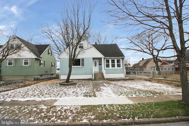 view of front of property with fence, a chimney, and entry steps