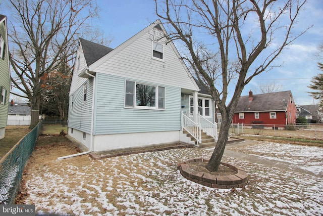 view of front of home featuring fence private yard and roof with shingles