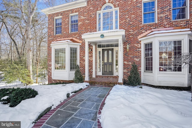 view of snow covered property entrance